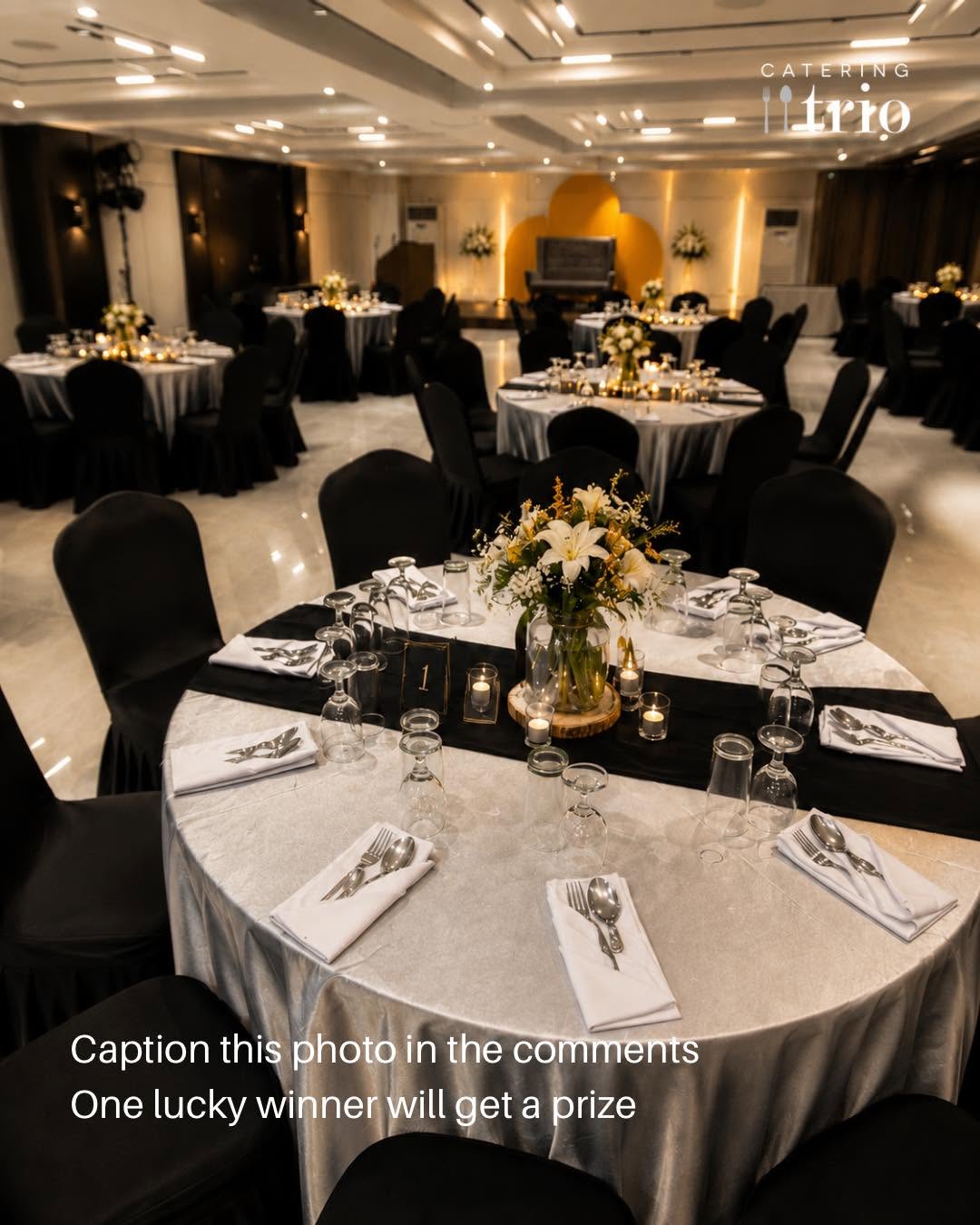 A real Catering Trio PH function room set for a formal dinner, round tables with white linens and gold accents